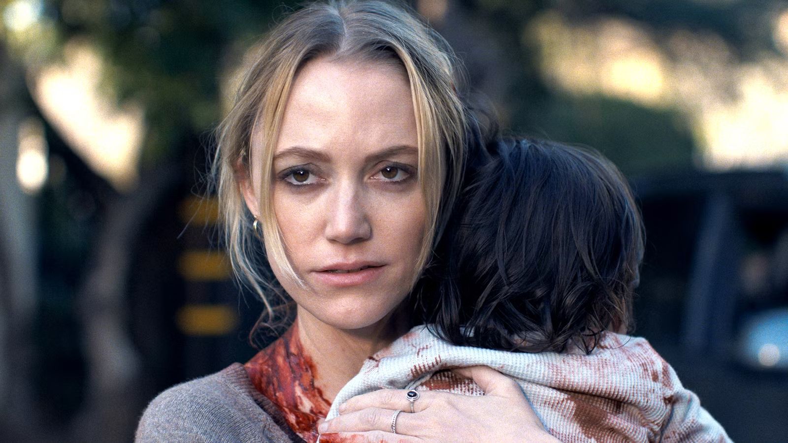 maika-monroe-as-polly-looking-suspiciously-while-holding-josie-in-the-hand-that-rocks-the-cradle